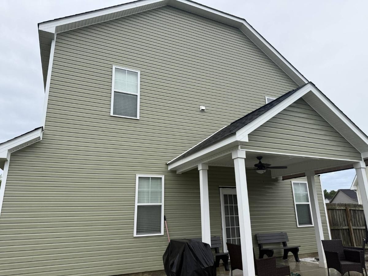 Clean, bright house exterior after professional pressure washing service, showcasing restored siding appearance