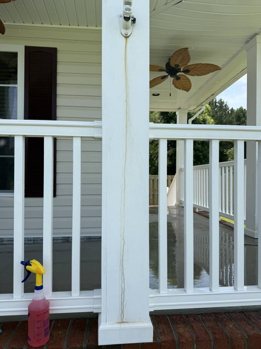 Stained wooden deck before cleaning showing weathered boards with dirt and organic growth