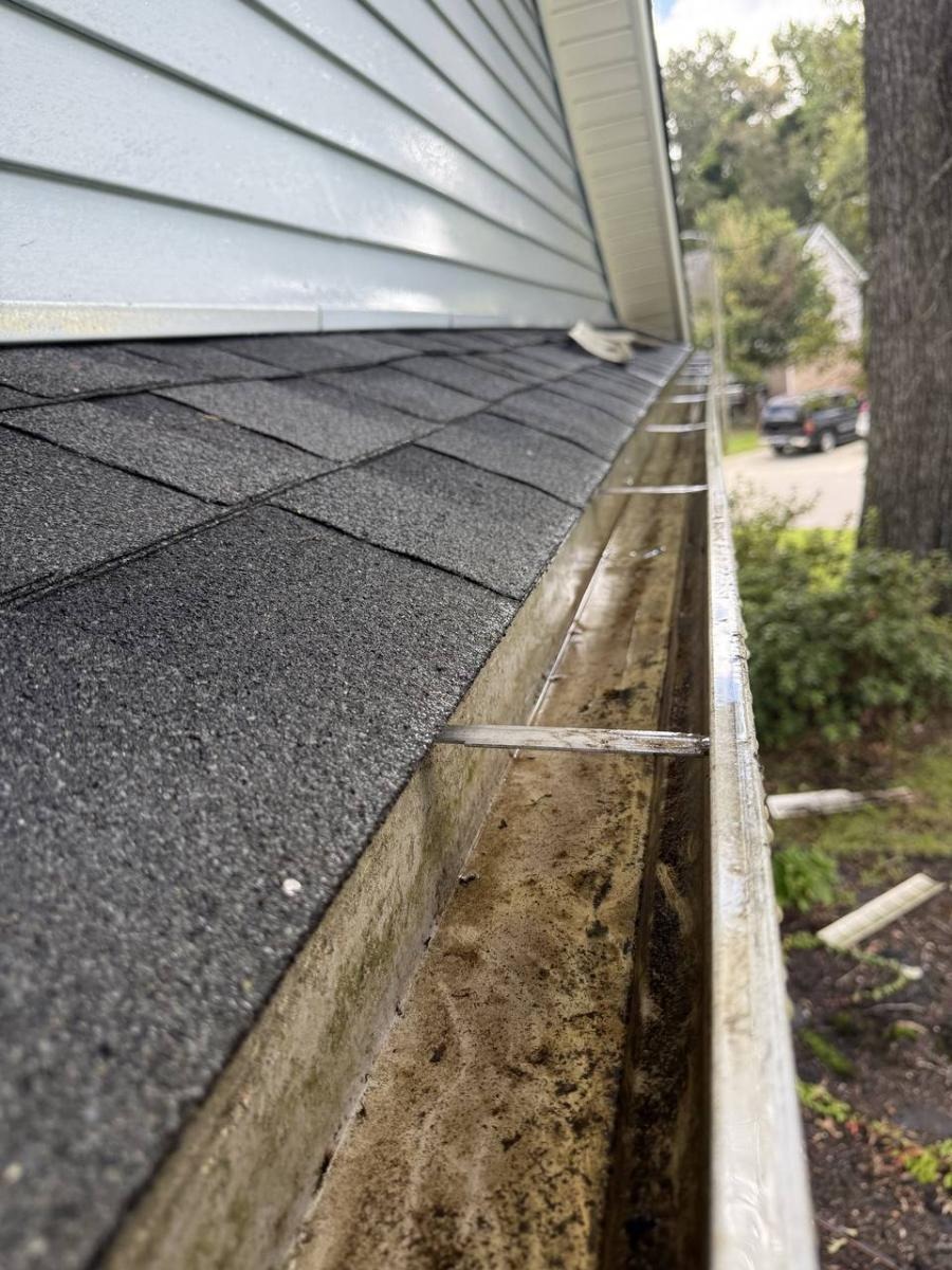 Professional gutter cleaning and maintenance service removing debris
