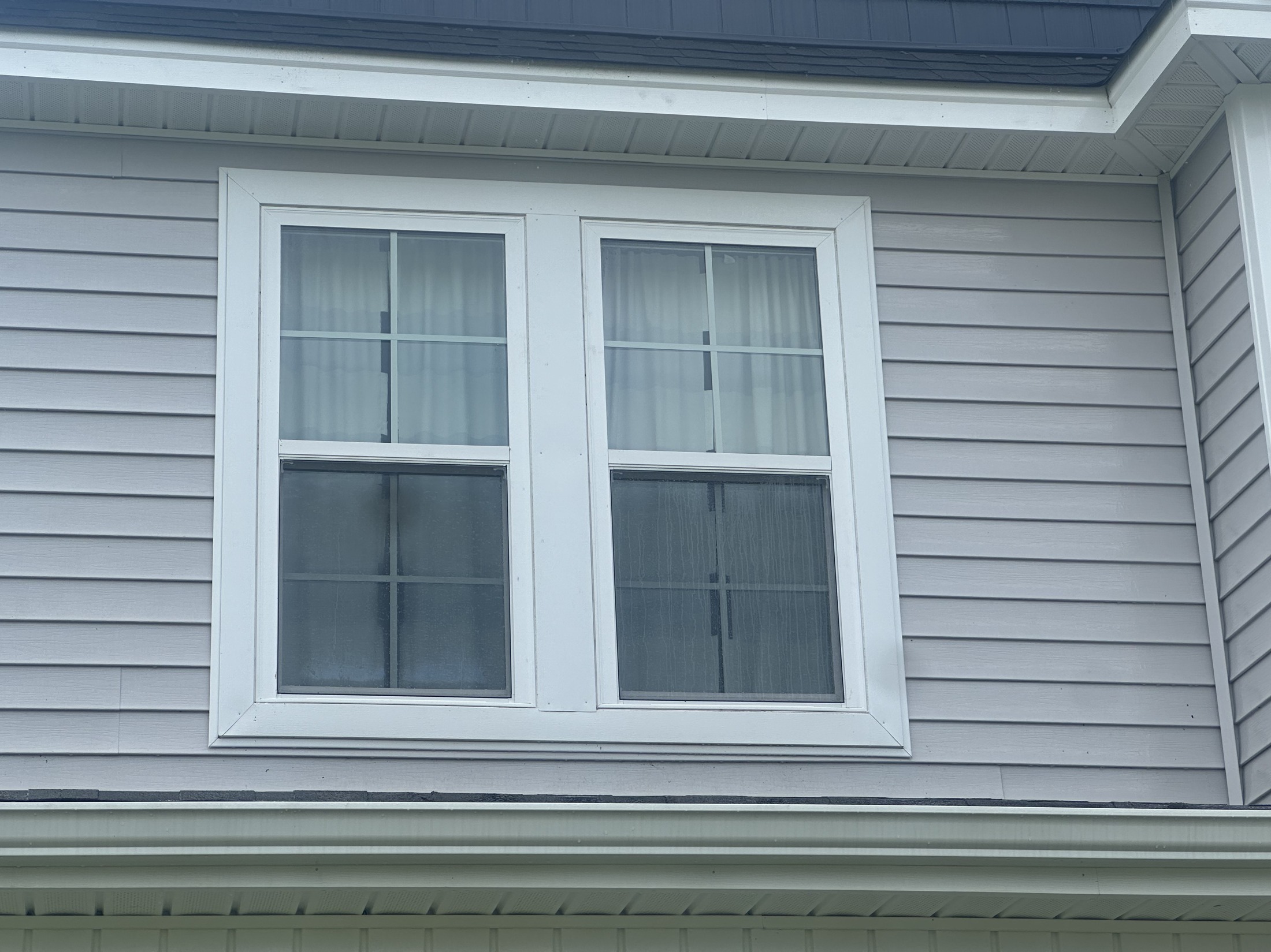 Professional window cleaning service leaving streak-free glass on a Jacksonville NC home